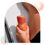 Hand holding refreshing Aspen Green Amalfi Spritz THC drink outdoors