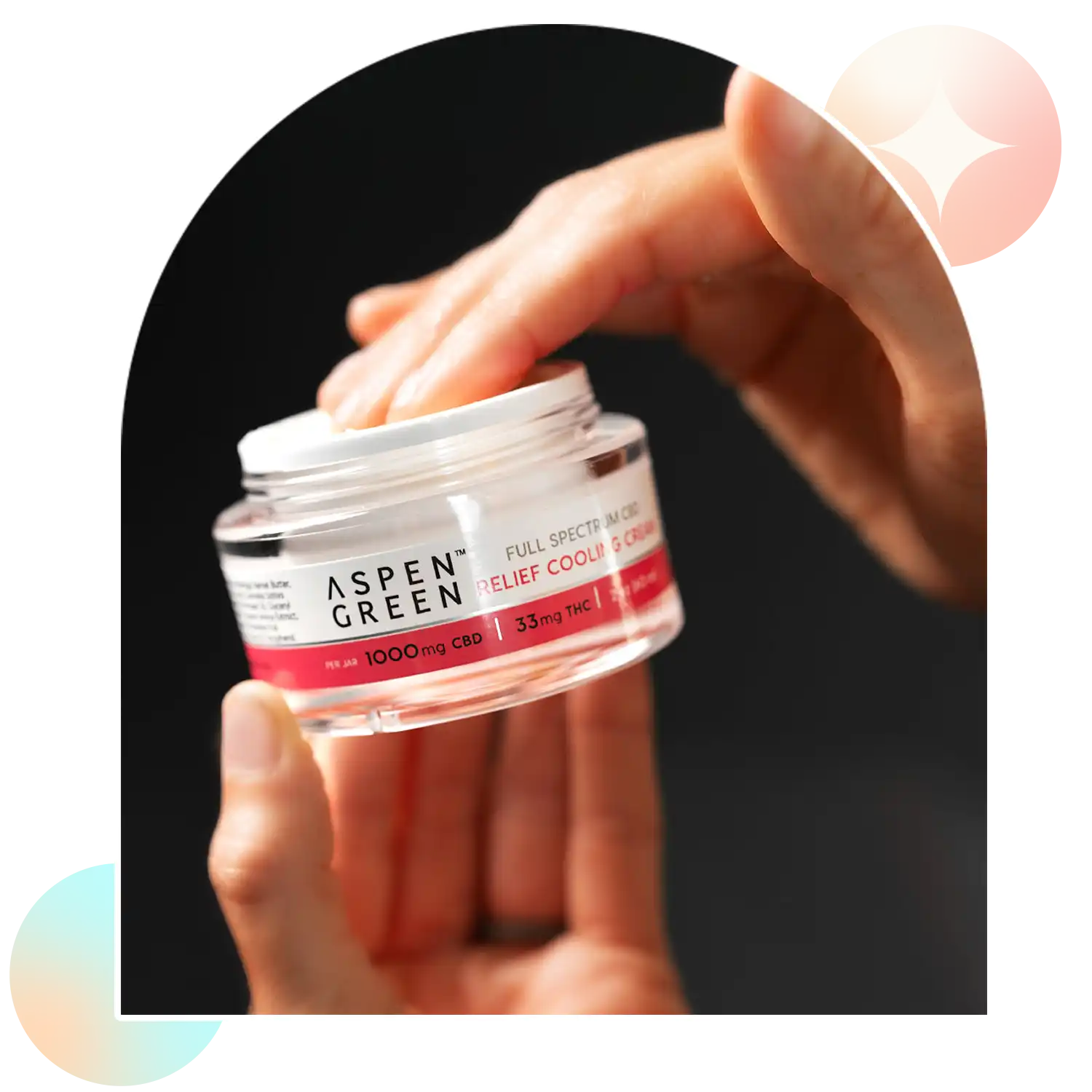 Hand grabbing Aspen Green Relief Cooling Cream from jar
