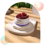 Open jar of Aspen Green USDA Certified Organic Rest CBD Gummies on a stone surface with a blurred outdoor background.