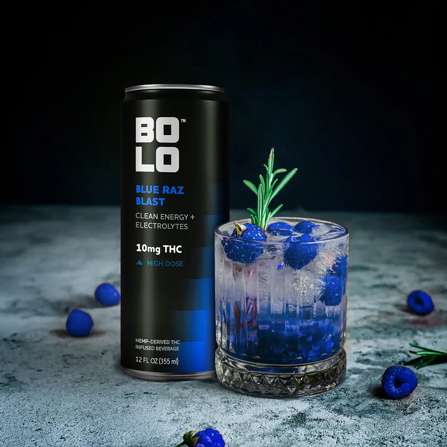BOLO Blue Raz Blast THC drink can with glass of raspberry flavored beverage and fresh raspberries